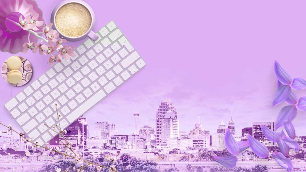 keyboard, mouse, pens, coffee, flowers, and macaroons with San Antonio Skyline